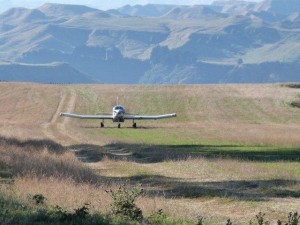 The fertiliser plane landing on the airstrip